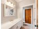 Clean bathroom features a white vanity with gold fixtures, a large mirror, and modern lighting at 2837 N Hills Ne Dr, Atlanta, GA 30305