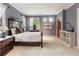 Bright bedroom features neutral paint, carpet, and white trim with a large bed and natural light at 2837 N Hills Ne Dr, Atlanta, GA 30305