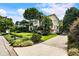 Inviting two-story home with a long driveway, lush lawn, mature trees, and colorful landscaping at 2837 N Hills Ne Dr, Atlanta, GA 30305