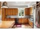 Traditional kitchen with stainless steel appliances, tile floors, and natural wood cabinetry at 2837 N Hills Ne Dr, Atlanta, GA 30305