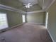 Main bedroom with neutral paint, large windows, ceiling fan and carpet flooring at 3426 Olivia Grace Way, Dacula, GA 30019