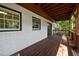 The covered back porch features brick walls and a stained wood deck at 4214 Williamsburg Dr, College Park, GA 30337