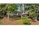 Exterior view of home showcasing a multi-tiered deck overlooking a lush backyard at 4214 Williamsburg Dr, College Park, GA 30337
