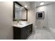 Modern bathroom featuring a stylish vanity with marble countertop and rectangular sink and large framed mirror at 4214 Williamsburg Dr, College Park, GA 30337