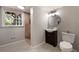 Basement bathroom with tiled shower, modern vanity, and window, allowing natural light at 4214 Williamsburg Dr, College Park, GA 30337
