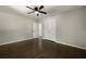Bedroom with hardwood floors, ceiling fan, and closet with white doors, and an open doorway at 4214 Williamsburg Dr, College Park, GA 30337