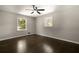 Empty bedroom with hardwood floors, two windows providing natural light, and neutral paint at 4214 Williamsburg Dr, College Park, GA 30337