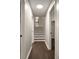 Hallway with stairs leading up, showing hardwood flooring and neutral paint at 4214 Williamsburg Dr, College Park, GA 30337