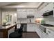 Modern kitchen boasts white cabinets, granite counters, stainless steel appliances, and a subway tile backsplash at 4214 Williamsburg Dr, College Park, GA 30337