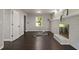 Bright living room features a brick fireplace, hardwood floors, and a sunlit window at 4214 Williamsburg Dr, College Park, GA 30337