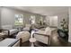 Spacious, neutral living room features windows for natural light, and contemporary furniture at 4214 Williamsburg Dr, College Park, GA 30337