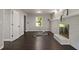 Spacious living room features hardwood floors and a painted brick fireplace at 4214 Williamsburg Dr, College Park, GA 30337