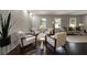 Bright living area featuring hardwood floors, a light-toned brick wall, four chairs, and natural light from large windows at 4214 Williamsburg Dr, College Park, GA 30337
