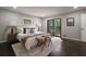 Main bedroom with hardwood floors, neutral paint, and access to a private balcony at 4214 Williamsburg Dr, College Park, GA 30337