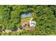 Expansive aerial shot of a property featuring a tennis court, uniquely shaped pool, house and lush trees at 52 Waterside Se Dr, Cartersville, GA 30121