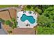 Aerial view of the uniquely shaped swimming pool area and the home's roof and the surrounding trees at 52 Waterside Se Dr, Cartersville, GA 30121