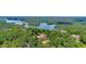 Stunning aerial shot of a luxury home, surrounded by lush greenery and the tranquil waters of Lake Keowee at 52 Waterside Se Dr, Cartersville, GA 30121