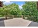 Open-air balcony with metal railing overlooks lush greenery and mature trees, providing a serene outdoor space at 52 Waterside Se Dr, Cartersville, GA 30121