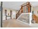 Basement staircase area featuring wood and stone accents, carpet, and art at 52 Waterside Se Dr, Cartersville, GA 30121