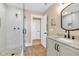 Bright bathroom featuring a glass shower, wood-look floors, vanity and a decorative mirror at 52 Waterside Se Dr, Cartersville, GA 30121