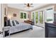 Comfortable bedroom with a ceiling fan, balcony access, and views of the surrounding nature at 52 Waterside Se Dr, Cartersville, GA 30121
