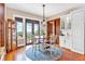Bright breakfast nook features hardwood floors, wainscoting, and windows with a view of the mountains and trees at 52 Waterside Se Dr, Cartersville, GA 30121