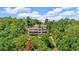 Multi-story home with multiple decks nestled among lush green trees, offering privacy and scenic views at 52 Waterside Se Dr, Cartersville, GA 30121