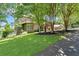 Charming home with a well-manicured lawn, mature trees, and attractive landscaping along the driveway at 52 Waterside Se Dr, Cartersville, GA 30121