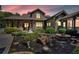 Beautifully landscaped front yard with lush gardens and a cozy fire pit area, perfect for outdoor entertaining at 52 Waterside Se Dr, Cartersville, GA 30121