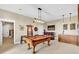 Spacious game room featuring a pool table, bar area, and ample seating at 52 Waterside Se Dr, Cartersville, GA 30121