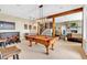 Entertaining billiards room with a bar area, stone fireplace, and access to the staircase at 52 Waterside Se Dr, Cartersville, GA 30121