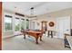 Well-lit billiards room with a classic pool table, seating, and balcony access at 52 Waterside Se Dr, Cartersville, GA 30121