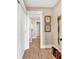 Hallway with closet, and bathroom access featuring neutral paint and wood-look flooring at 52 Waterside Se Dr, Cartersville, GA 30121