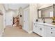 Neutral hallway with access to staircase, and includes decorative vanity and storage at 52 Waterside Se Dr, Cartersville, GA 30121
