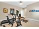 Fully equipped home gym with treadmill, stationary bike, and weight training equipment at 52 Waterside Se Dr, Cartersville, GA 30121