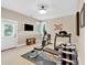 Well-lit home gym featuring weight training equipment and a mounted TV at 52 Waterside Se Dr, Cartersville, GA 30121