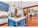 Bright eat-in kitchen features a large island with seating and pendant lighting, stainless steel appliances, and hardwood floors at 52 Waterside Se Dr, Cartersville, GA 30121