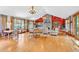 Spacious living room boasts hardwood floors, stone fireplace, a vaulted ceiling, and natural light through large windows at 52 Waterside Se Dr, Cartersville, GA 30121