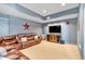 Cozy living room with a large leather sectional couch, TV, and star decorations at 52 Waterside Se Dr, Cartersville, GA 30121
