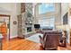 Two-story living room features hardwood floors, stone fireplace, a wall of windows, and plenty of natural light at 52 Waterside Se Dr, Cartersville, GA 30121