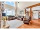 Two-story living room features hardwood floors, a stone fireplace, a wall of windows, and access to the eat-in kitchen at 52 Waterside Se Dr, Cartersville, GA 30121