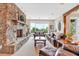 Cozy living room with stone fireplace, leather seating, and outdoor view at 52 Waterside Se Dr, Cartersville, GA 30121