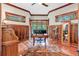 Executive office with wood paneled walls, hardwood floors, and large windows offering natural light at 52 Waterside Se Dr, Cartersville, GA 30121
