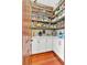 Walk-in pantry with custom shelving, ample counter space, and wood floors provides tons of storage for food and supplies at 52 Waterside Se Dr, Cartersville, GA 30121