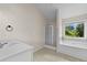 Bright bathroom featuring a large window, shower, and vanity at 6468 Panasa Ct, Tucker, GA 30084