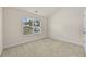 Bedroom featuring plush carpet, a window with backyard views, and ample natural light creating a cozy and inviting atmosphere at 6468 Panasa Ct, Tucker, GA 30084