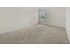 Bedroom featuring plush carpet, a window with backyard views, and ample natural light creating a serene atmosphere at 6468 Panasa Ct, Tucker, GA 30084