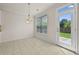 Cozy dining area with tile floors, backyard views, and modern chandelier at 6468 Panasa Ct, Tucker, GA 30084