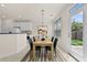Bright dining area with a modern table setting and a view of the backyard through a glass door at 6468 Panasa Ct, Tucker, GA 30084