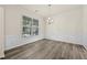 Bright dining area with wainscoting, a modern light fixture, and lots of natural light at 6468 Panasa Ct, Tucker, GA 30084